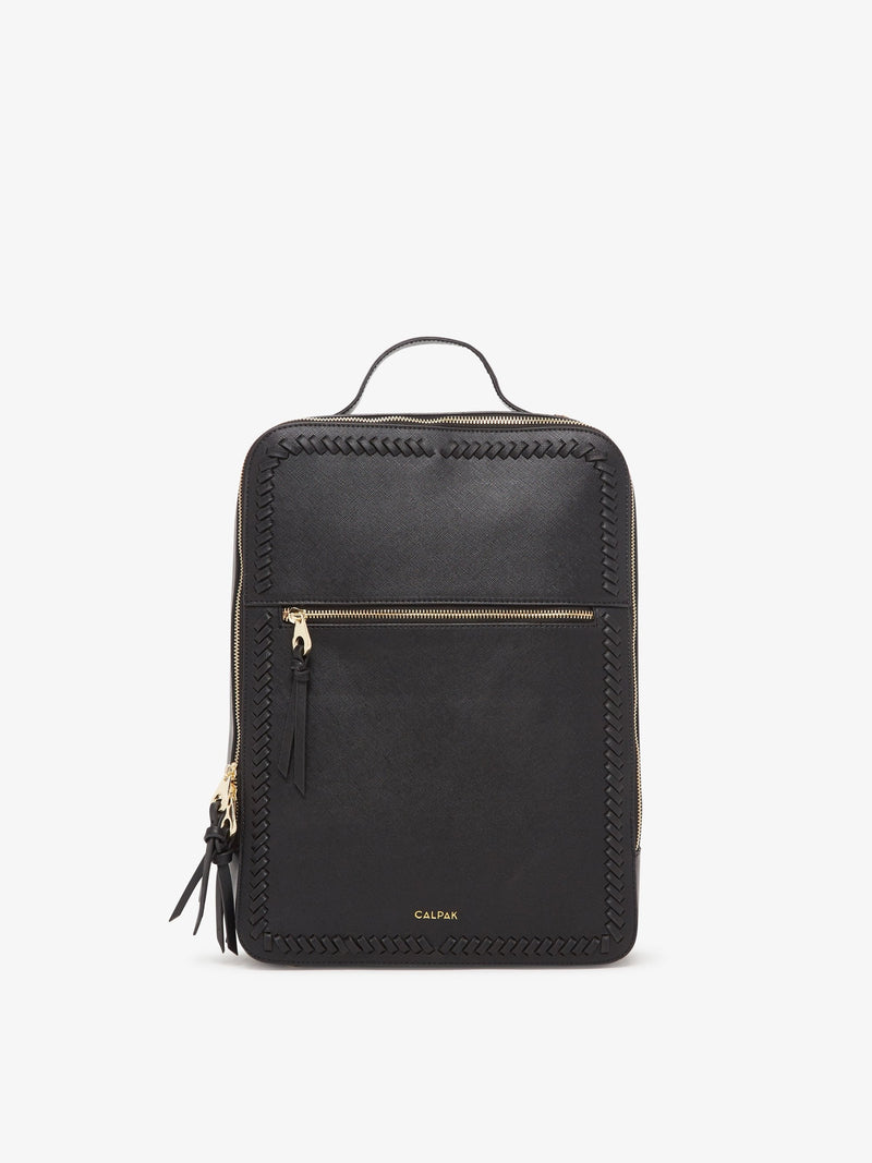 The Kaya Laptop Backpack in black, featuring a minimalist design with a top handle, front zippered pocket, and adjustable shoulder straps