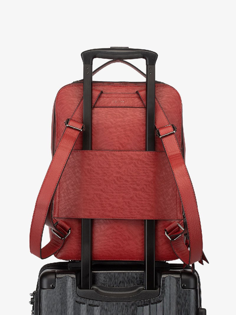 red CALPAK Kaya laptop backpack with luggage trolley sleeve