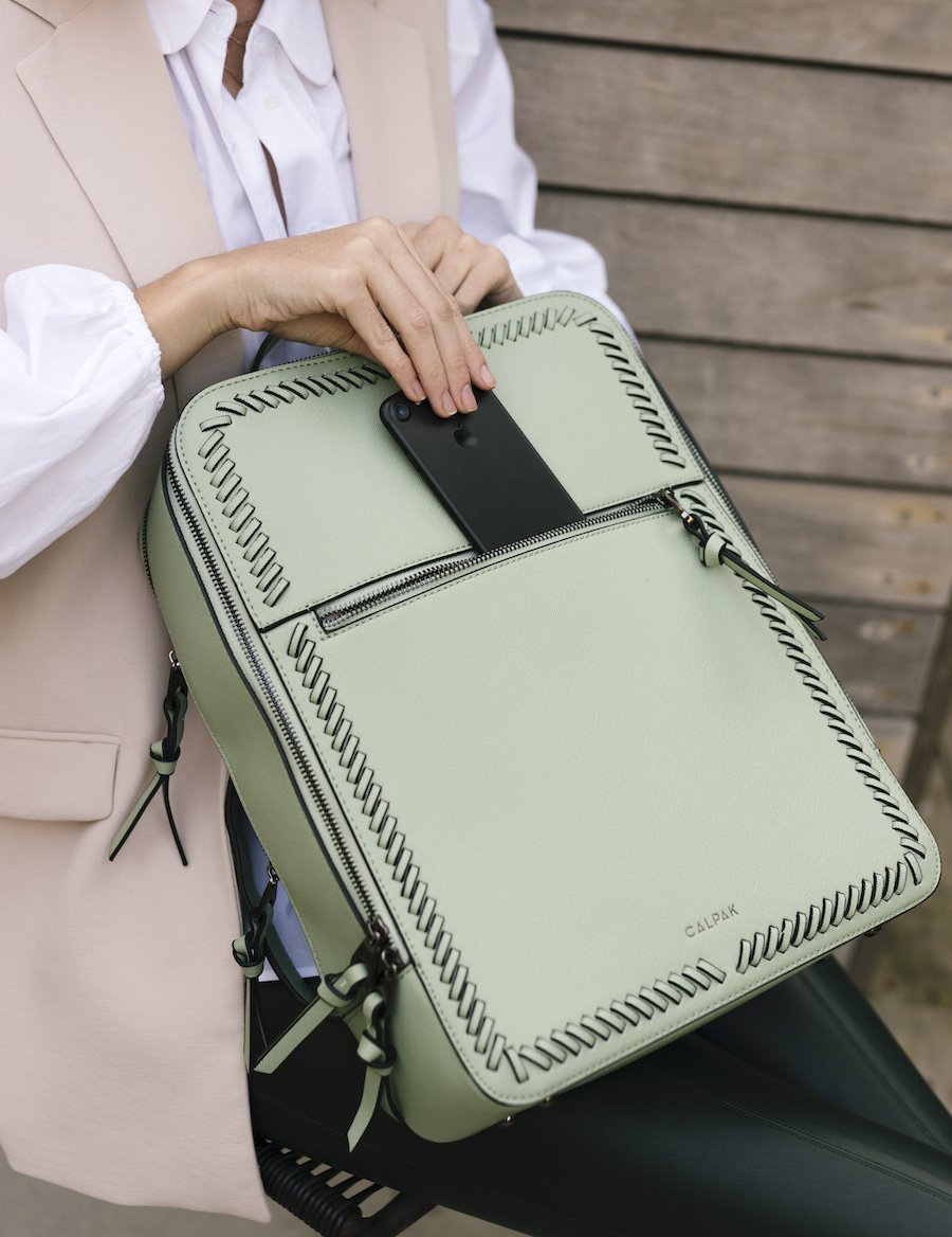 women holding mint CALPAK Kaya laptop backpack