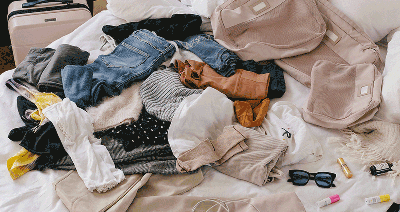 Gif of CALPAK Packing Cubes 5 piece set in Pink Sand, showing unorganized clothes being organized into the packing cubes