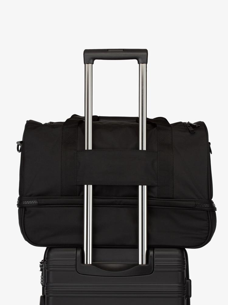 black CALPAK Stevyn duffel bag with luggage trolley sleeve
