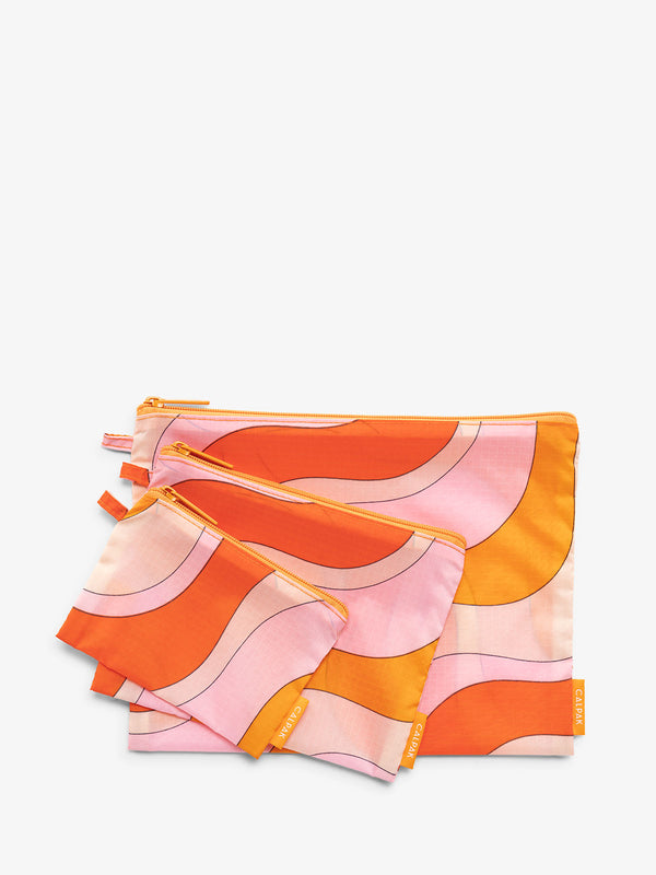 Orange and Pink Calpak set of storage pouches for organization in wavy red pattern