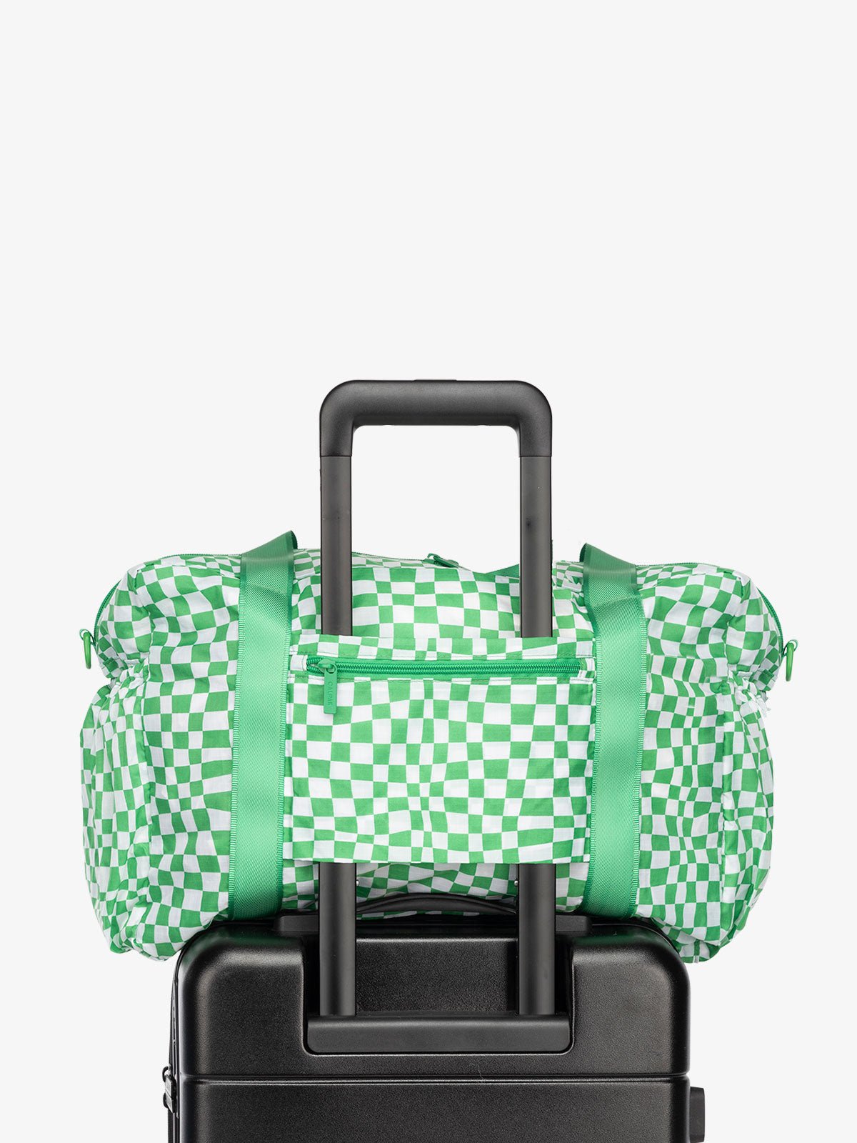 CALPAK Compakt nylon duffle bag with trolley sleeve and zippered pocket in green checkerboard pattern