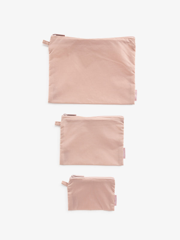 Set of pink zippered pouches for organization and travel