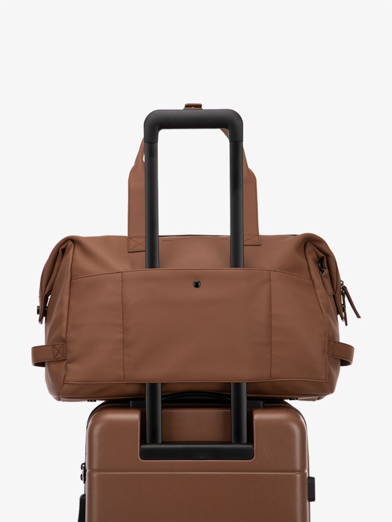 brown hazel CALPAK Hue duffel bag with luggage trolley sleeve