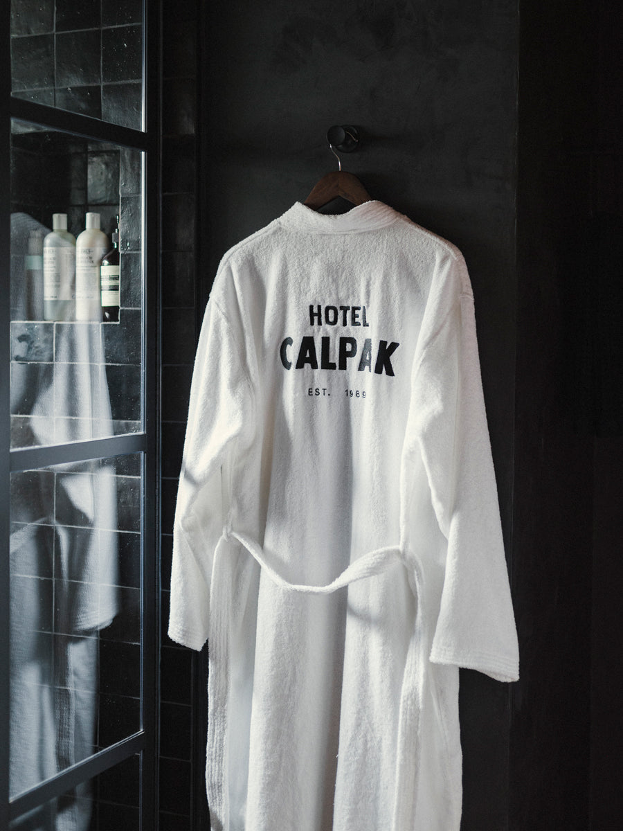Hotel CALPAK white cotton bathrobe with Hotel CALPAK logo