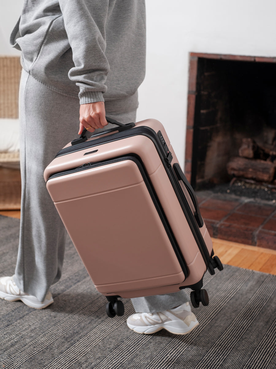 pink CALPAK Hue hardside carry on suitcase with laptop compartment