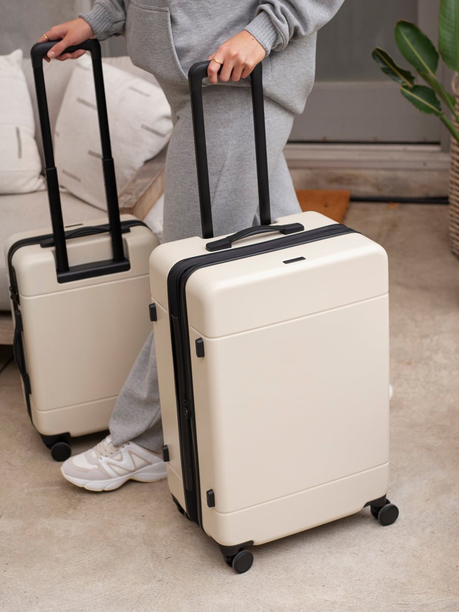 medium 26 inch CALPAK Hue hard shell luggage in cream linen