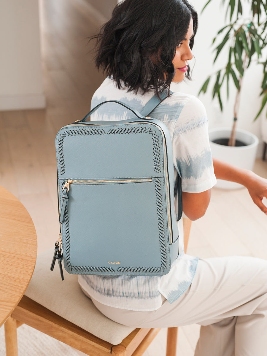 CALPAK Kaya Laptop Backpack for women in bluebell color modelled
