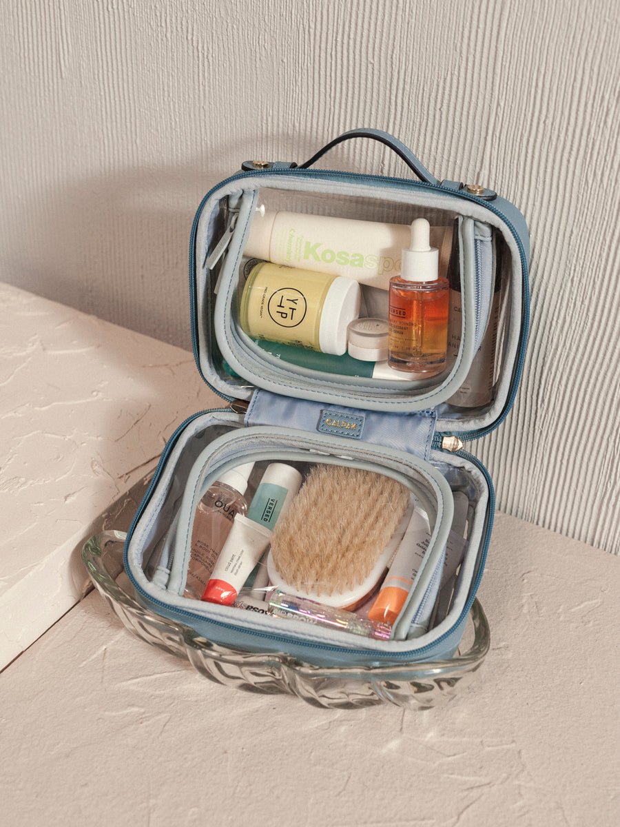 mini clear cosmetics case with handle and zippered compartments