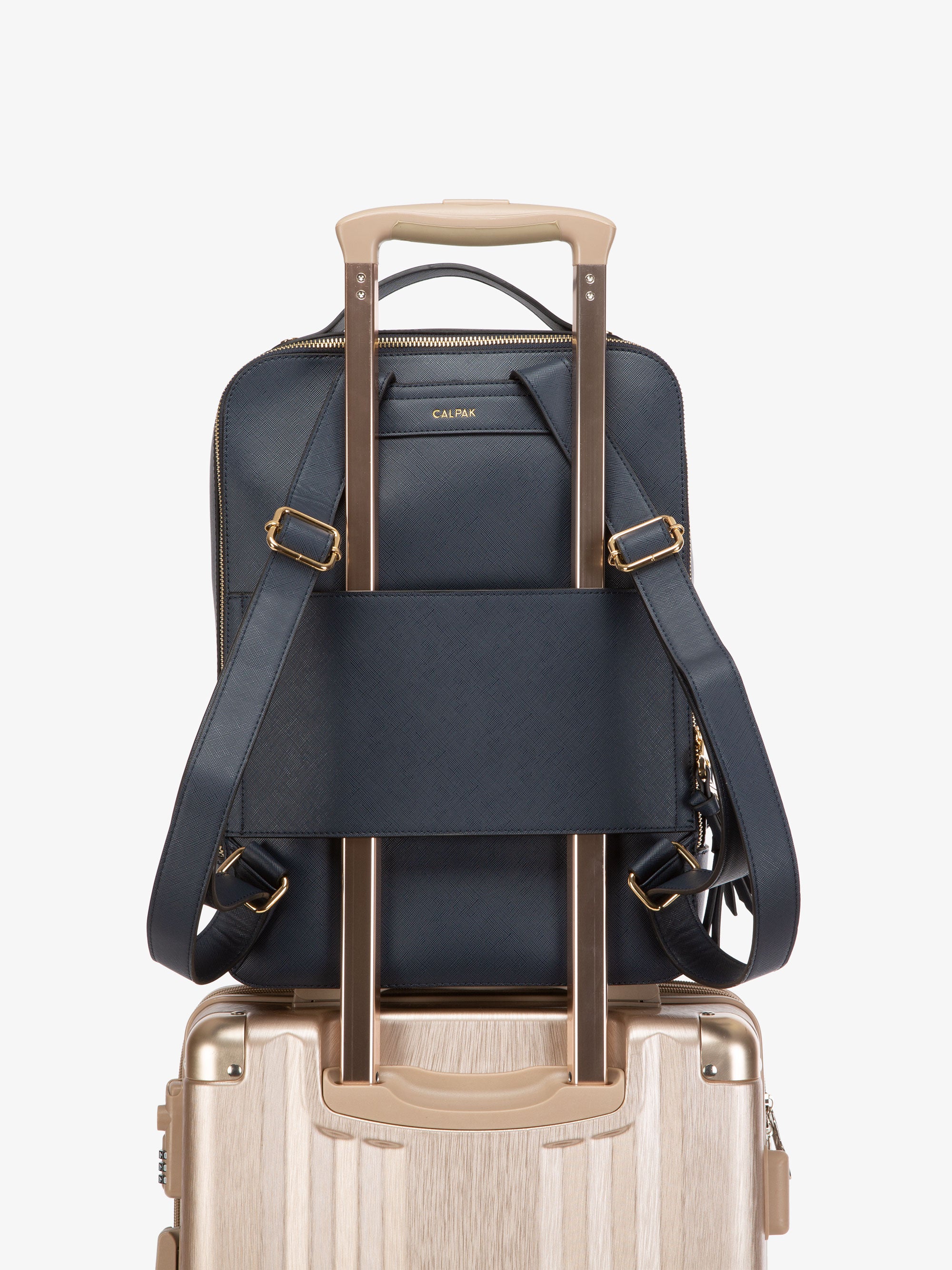 navy blue CALPAK Kaya laptop backpack with luggage trolley sleeve