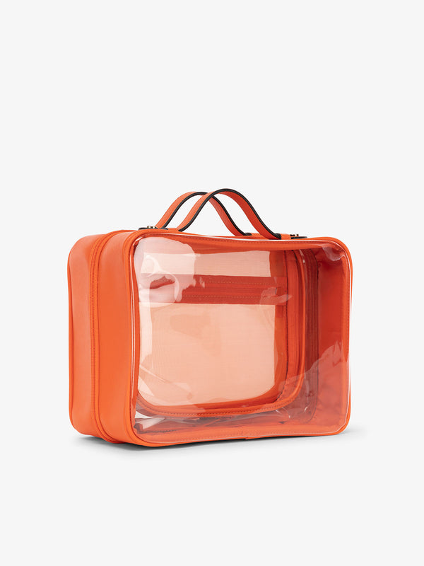 CALPAK large clear skincare bag with multiple zippered compartments in orange