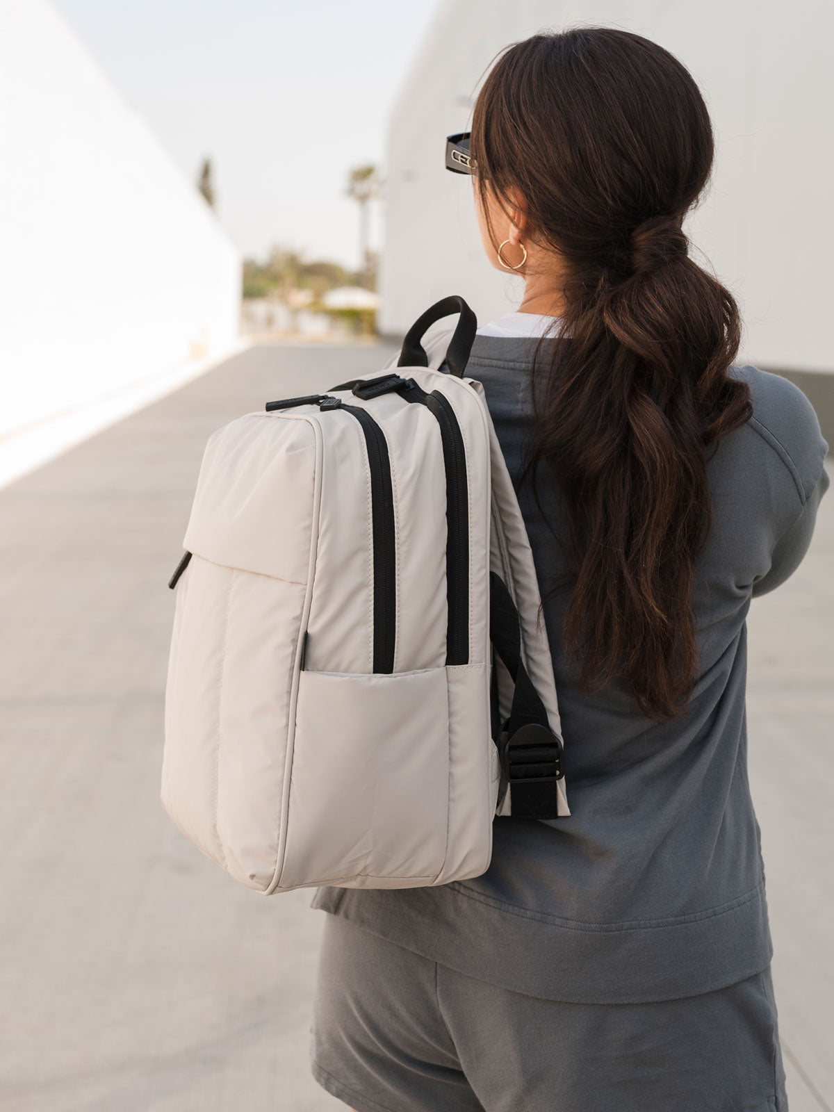 model with Luka Laptop Backpack in dove grey