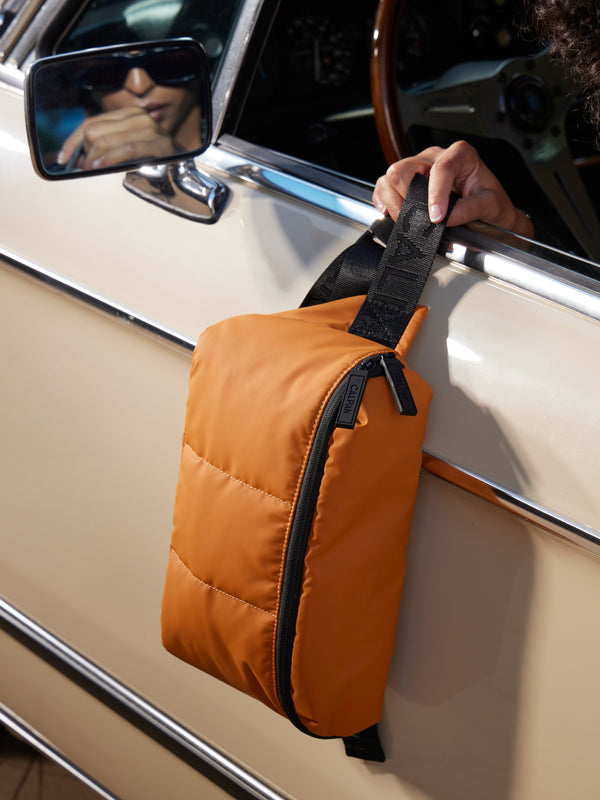 CALPAK Luka Belt Bag side view with front zippers in pumpkin