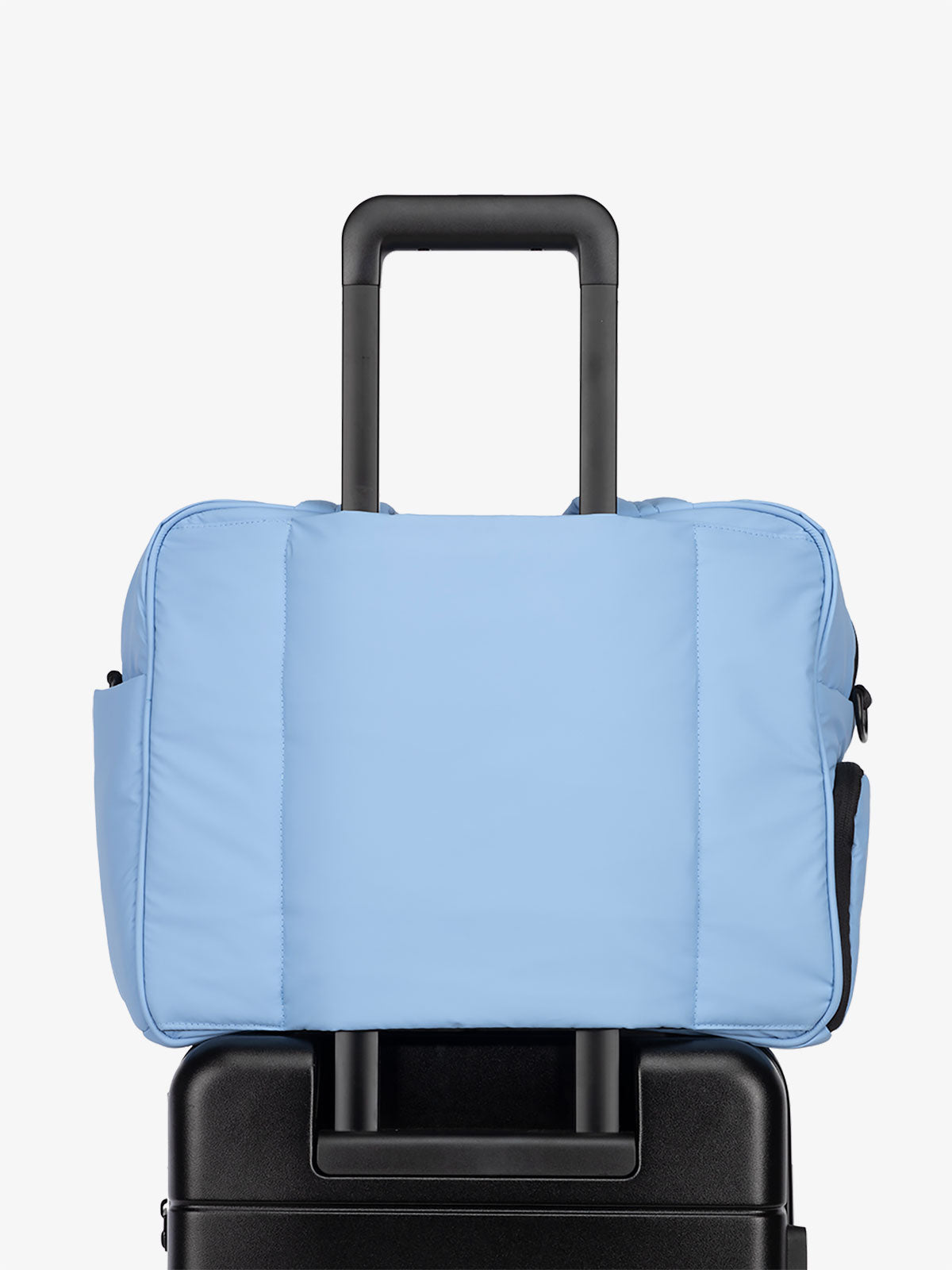 CALPAK Luka Weekender Duffel Bag with trolley sleeve for travel in winter sky