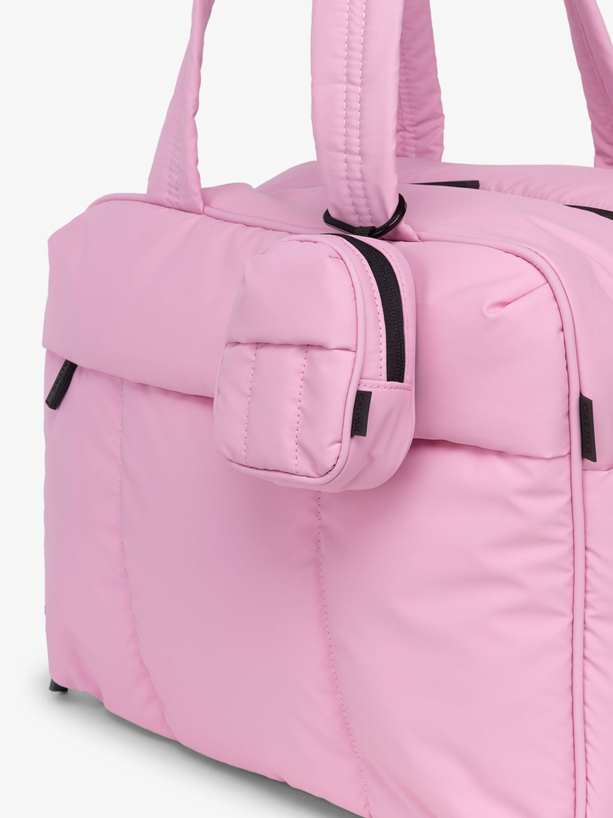 CALPAK Luka mini backpack keychain attached to duffel with soft, water-resistant exterior in pink