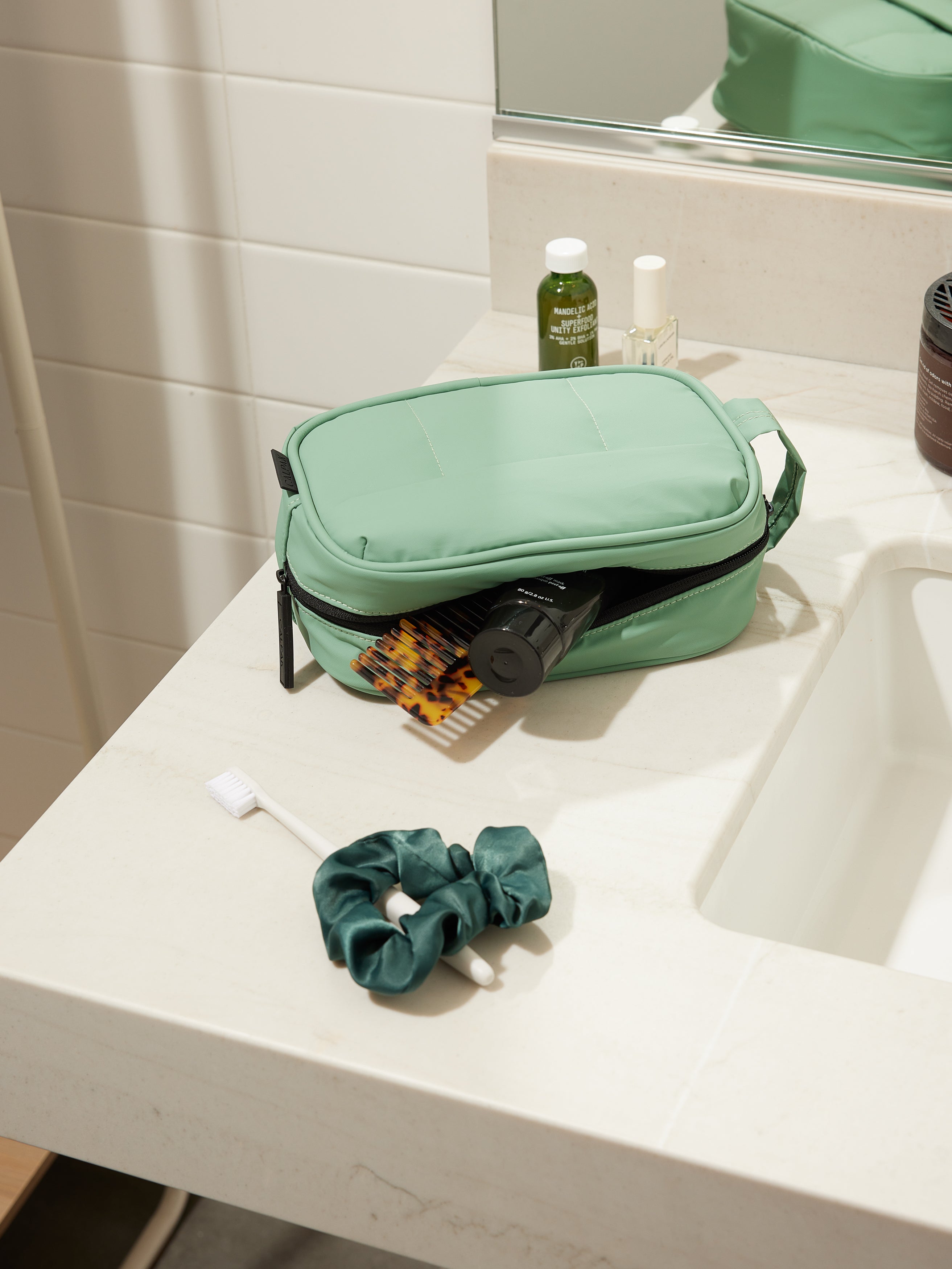 CALPAK Luka Toiletry Bag for women with water resistant lining in sage green