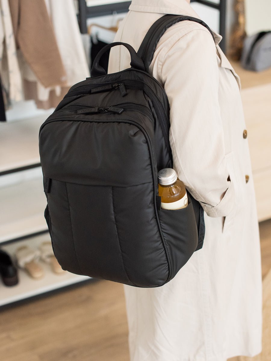 black Luka travel backpack with luggage sleeve