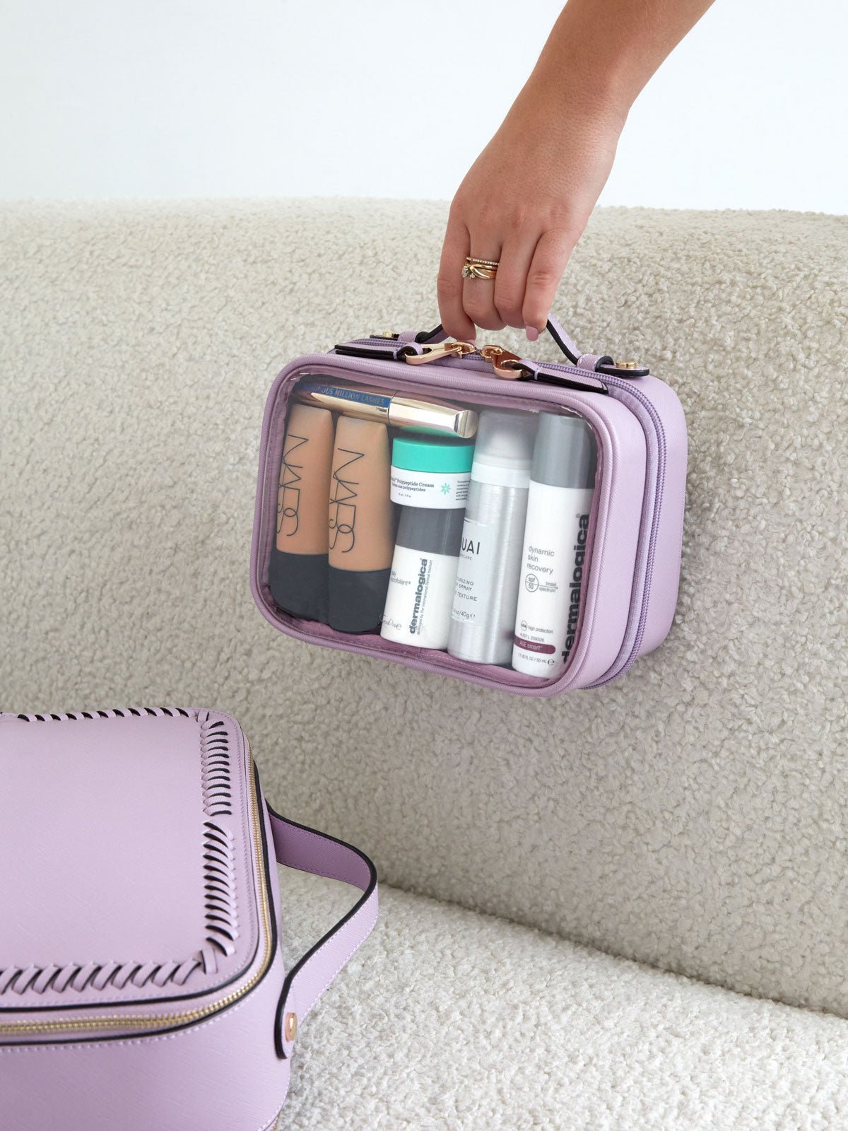 small clear cosmetics case with handle in lavender purple