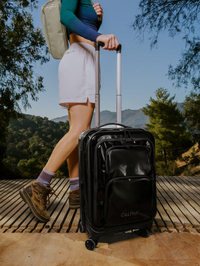 Studio product shot of front-facing CALPAK Terra Carry-On luggage with soft shell and 360 spinner wheels in obsidian; model LTE1020-OBSIDIAN