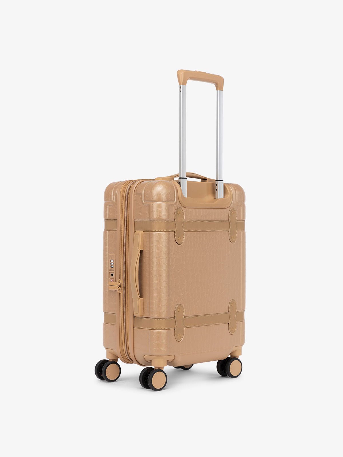 beige almond hard shell CALPAK TRNK suitcase with four 360 wheels in vintage trunk style carry-on luggage