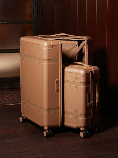 large 29 inch beige almond hard shell CALPAK TRNK suitcase with four 360 wheels in vintage trunk style; LTK1028-ALMOND