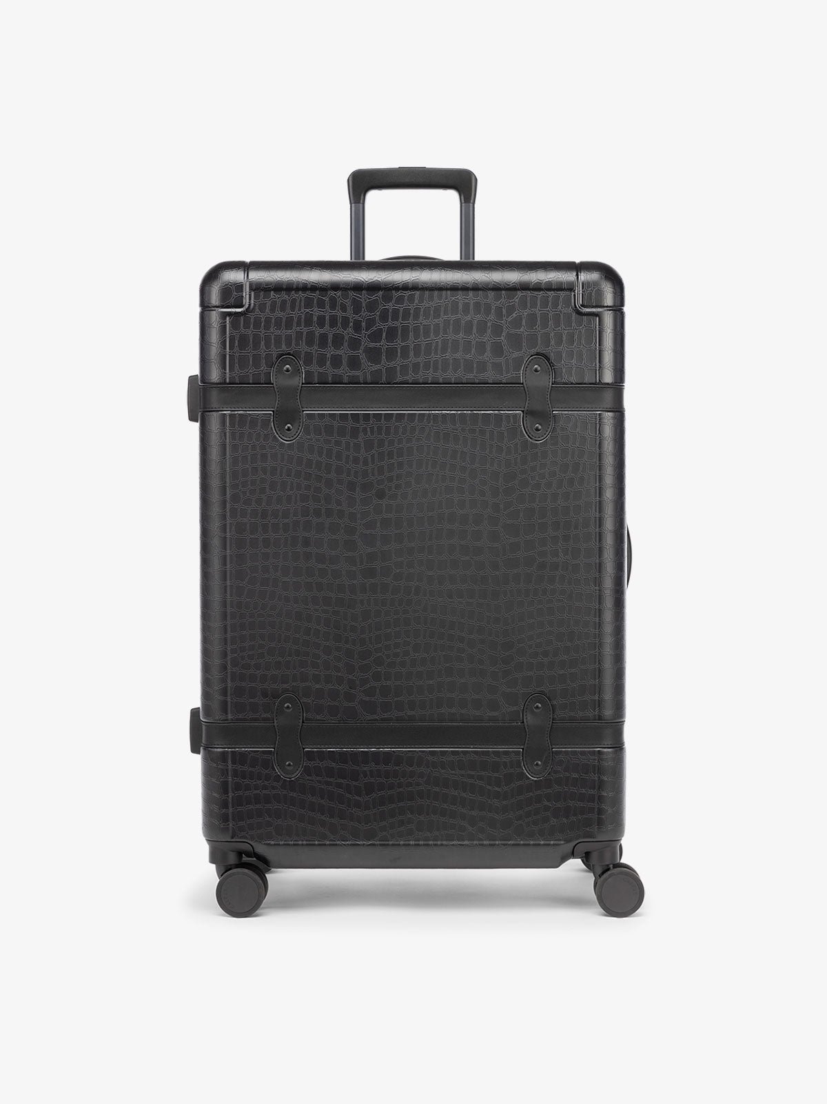 large 29 inch black hard shell CALPAK TRNK suitcase with four 360 wheels in vintage trunk style
