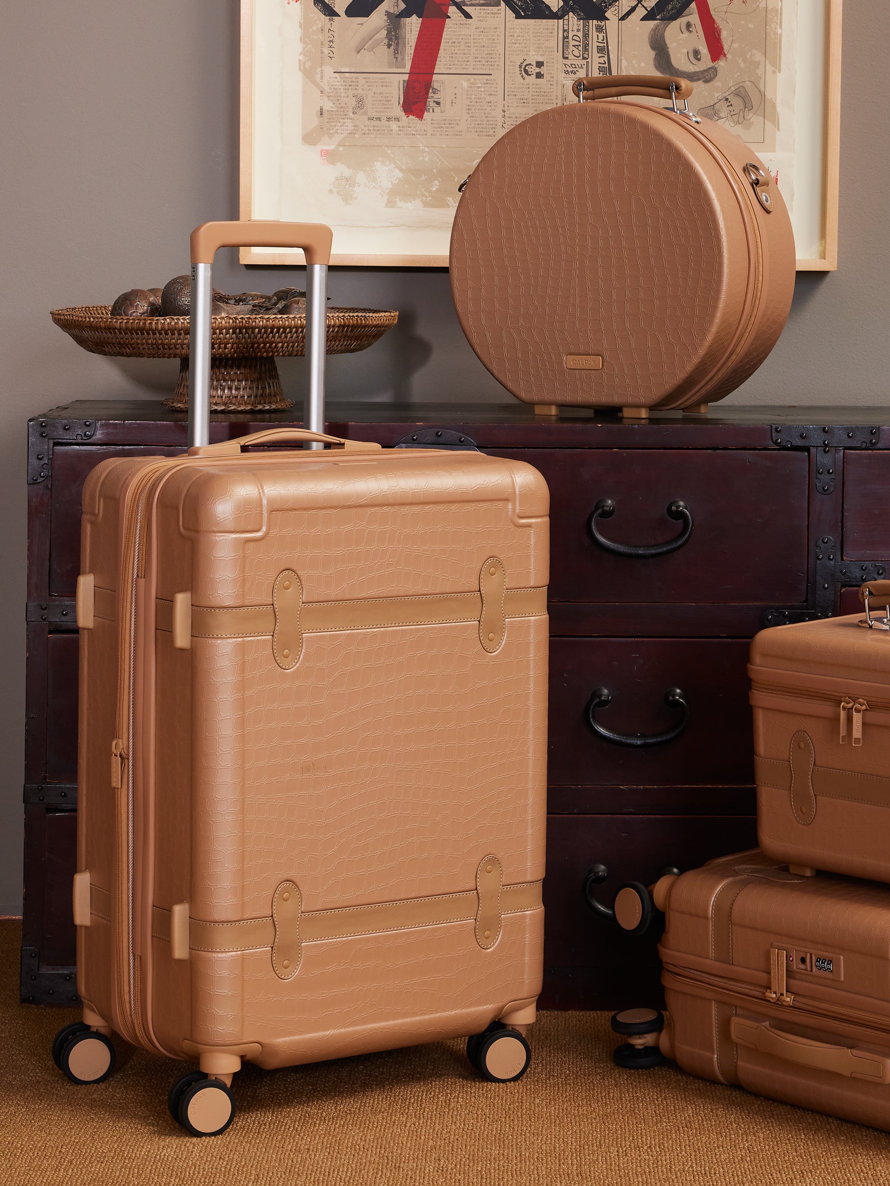 25 inch rolling hard shell beige almond suitcase as a part of CALPAK TRNK luggage collection in vintage trunk style