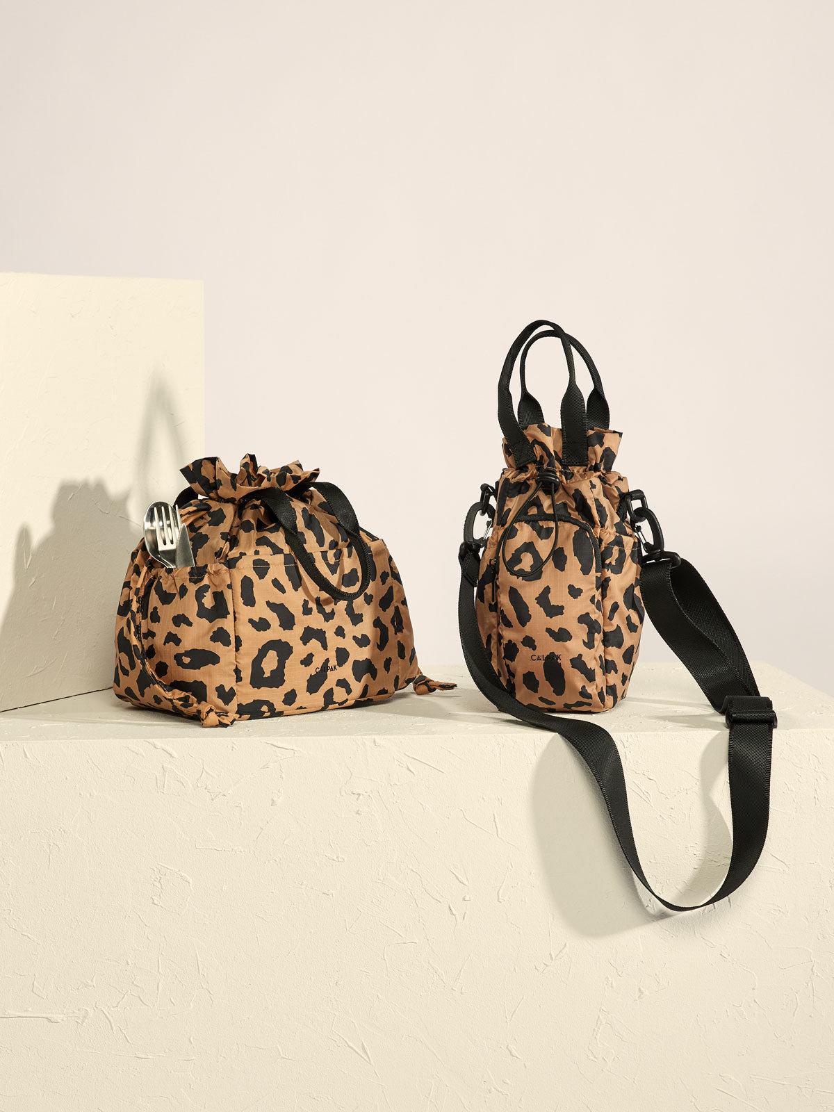 water bottle carrier with crossbody strap in cheetah