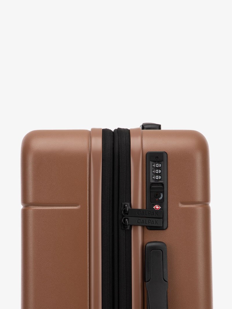 TSA lock of CALPAK Hue hard shell rolling carry-on luggage in brown hazel color
