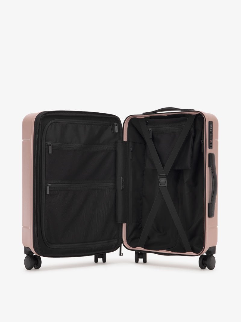 the interior of CALPAK Hue hard shell carry-on spinner luggage in pink sand color