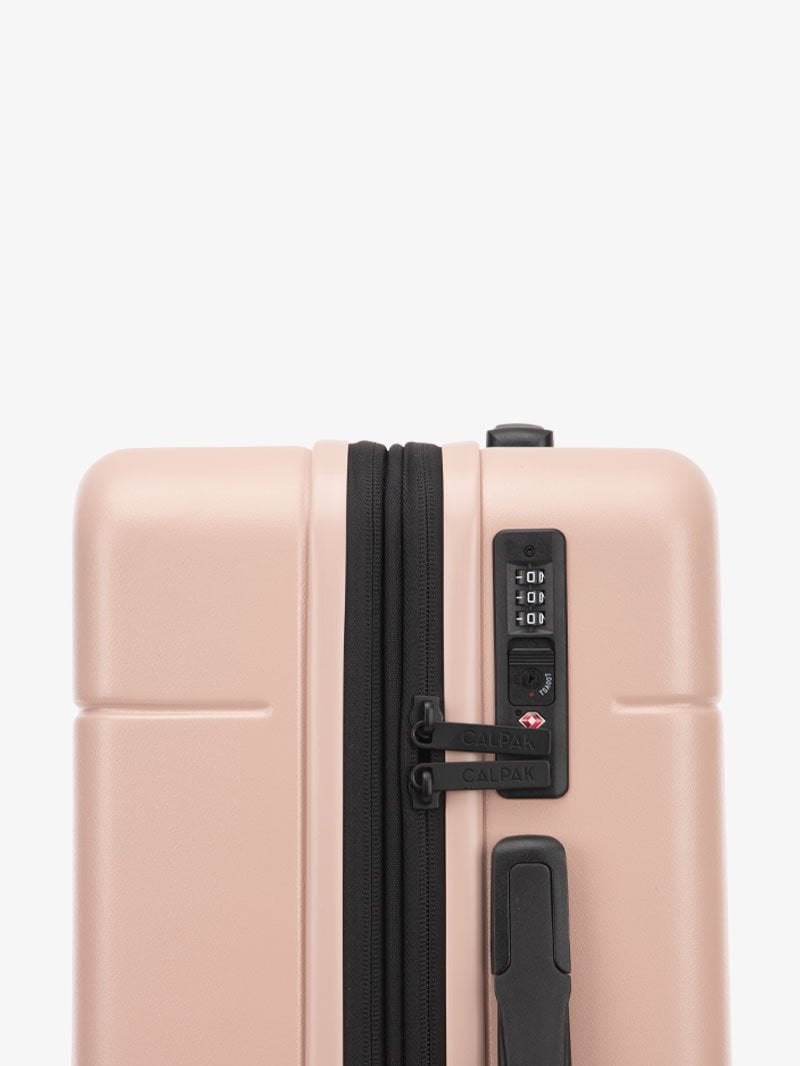TSA lock of CALPAK Hue hard side carry-on luggage with spinner wheels in pink sand color