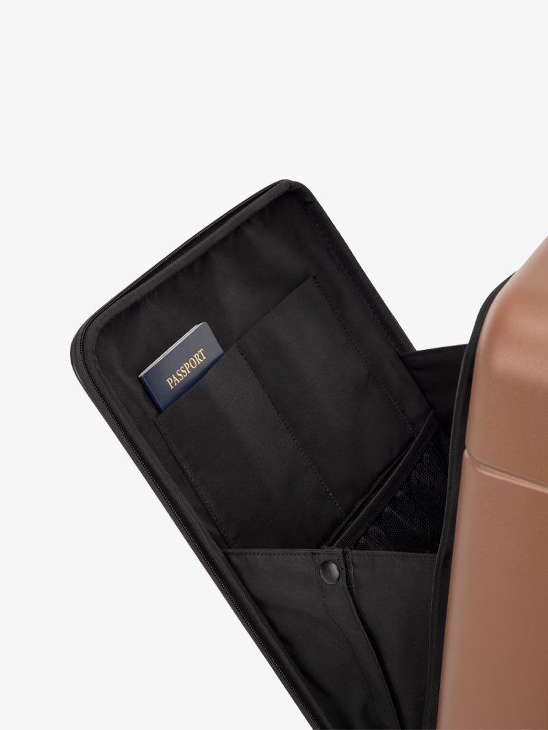 the laptop compartment of CALPAK Hue carry-on suitcase in brown hazel color