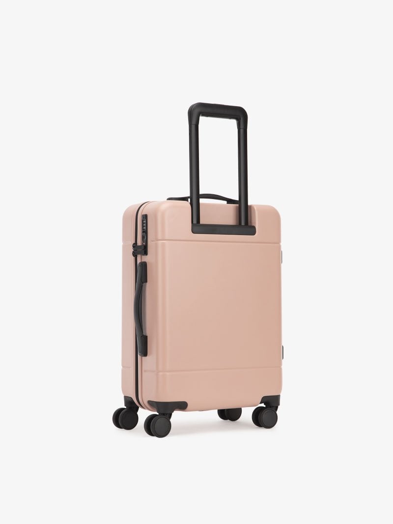 CALPAK Hue lightweight polycarbonate carry-on suitcase with laptop pocket in pink sand color