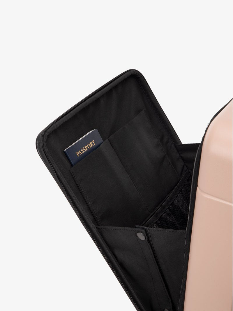 the laptop compartment of CALPAK Hue carry-on suitcase in pink sand color