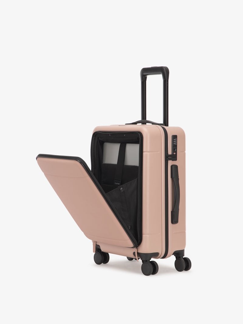 pink CALPAK Hue hard shell carry-on spinner luggage with laptop compartment