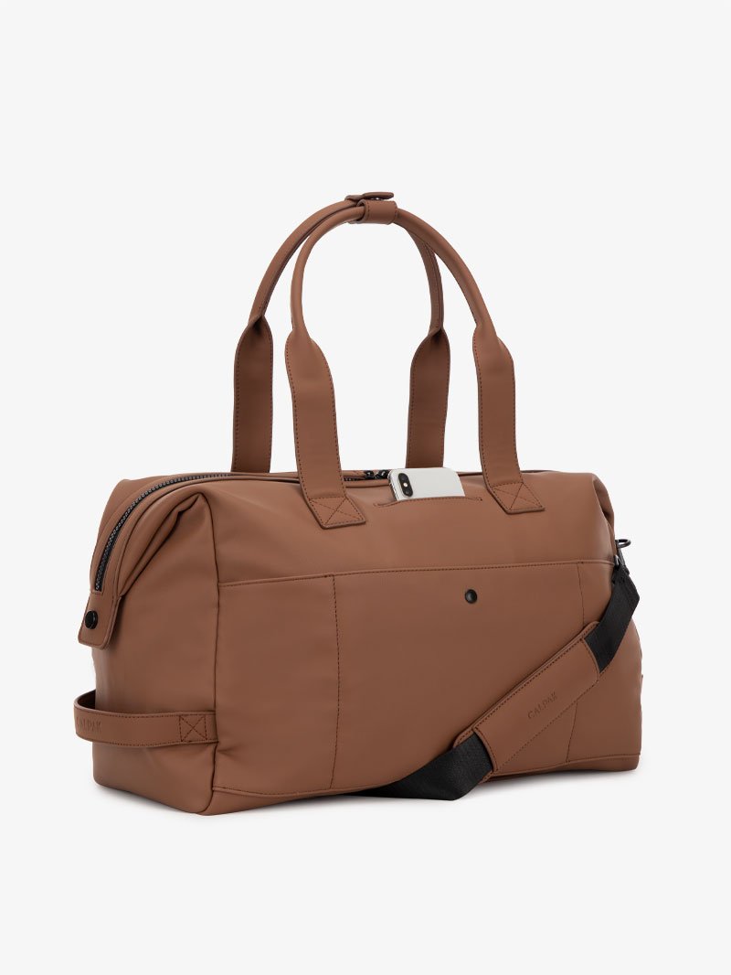man with brown hazel CALPAK Hue duffel bag