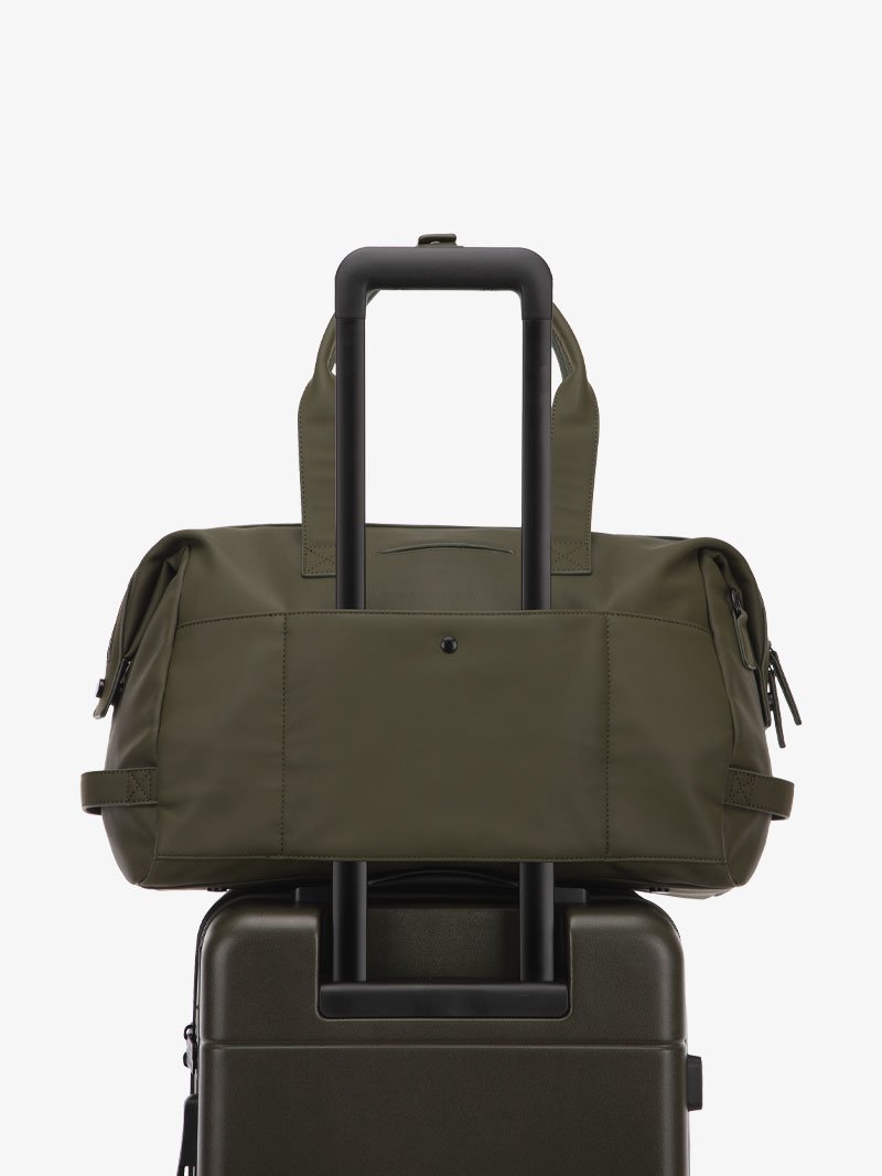 green moss CALPAK Hue duffel bag with luggage trolley sleeve