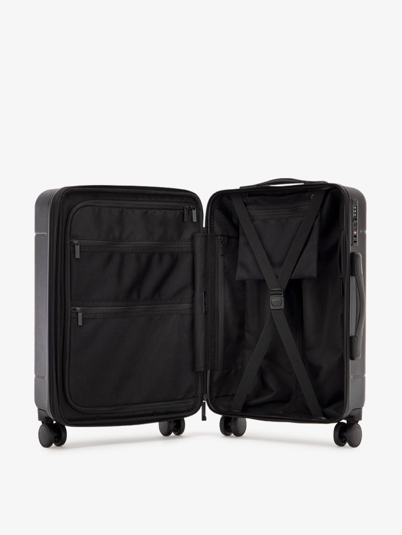 medium size black CALPAK Hue suitcase with compression straps