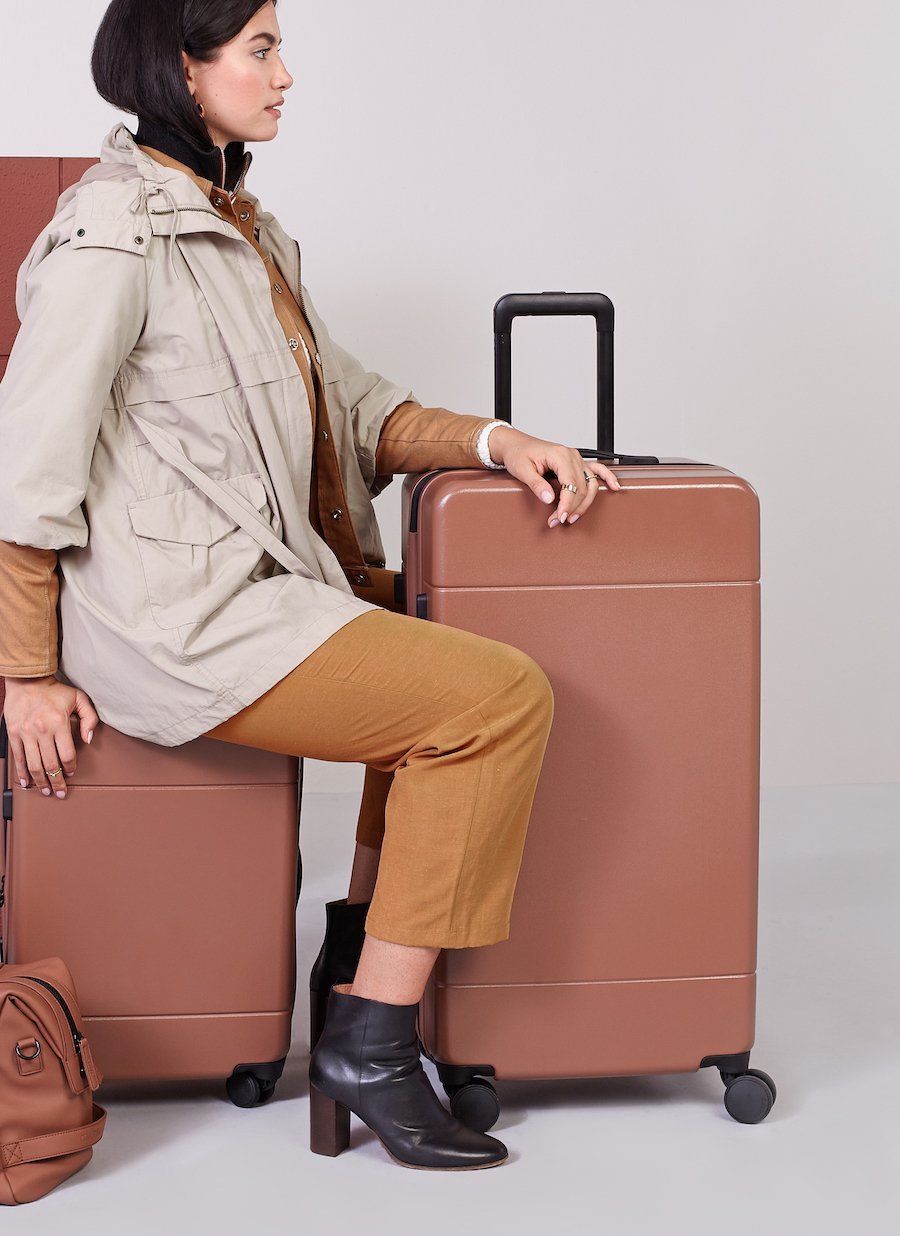 model with check in suitcase and trunk luggage from Hue luggage collection