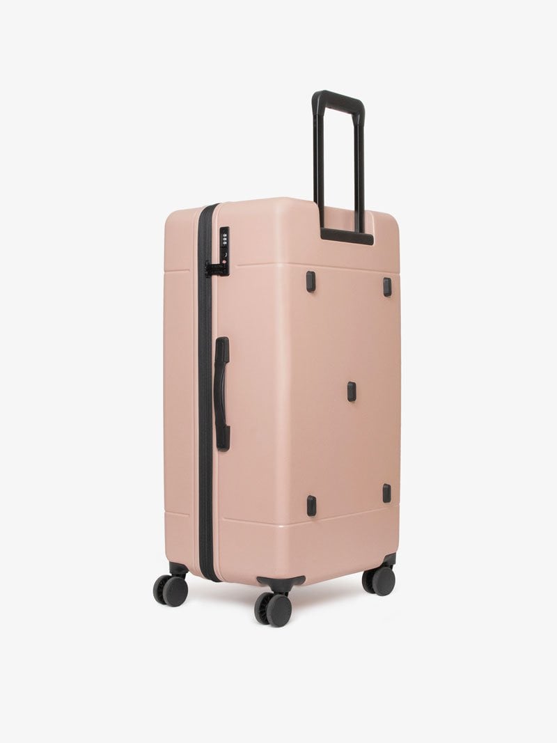 CALPAK Hue 31 inch hard shell trunk luggage with 360 spinner wheels in pink sand color