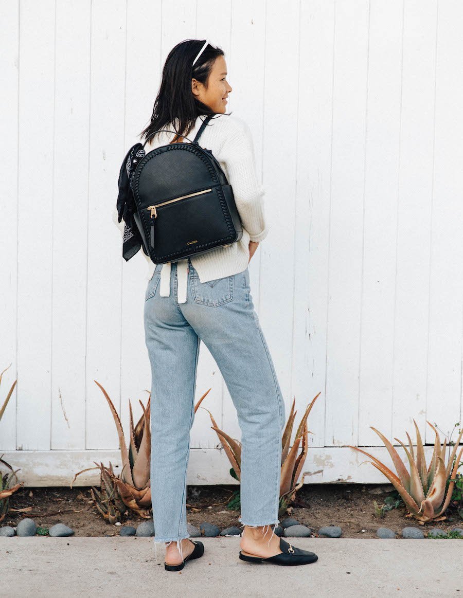 female model with black CALPAK Kaya backpack