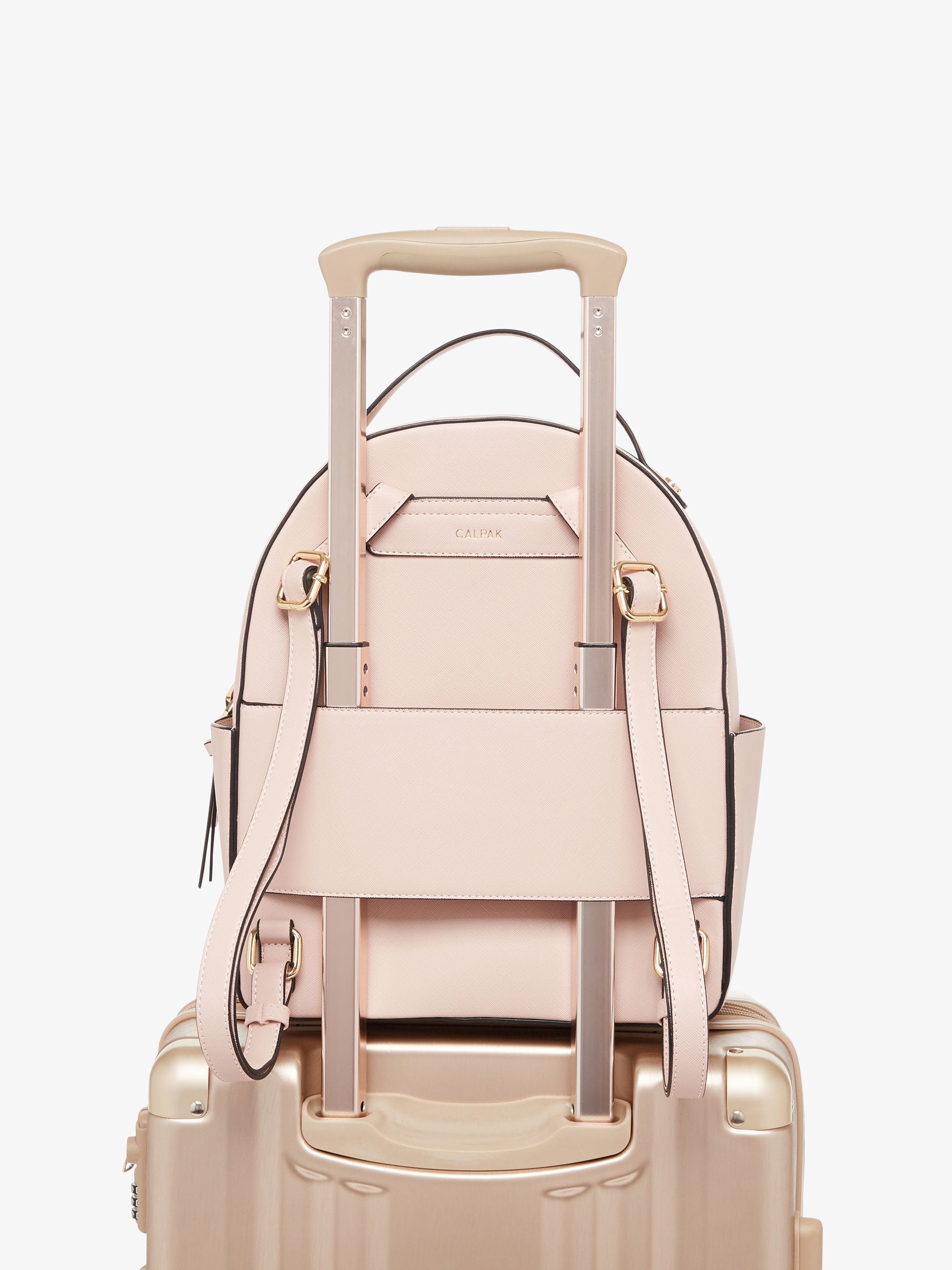 Pink blush CALPAK Kaya backpack with luggage trolley sleeve