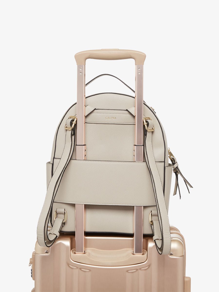 Beige CALPAK Kaya backpack with luggage trolley sleeve