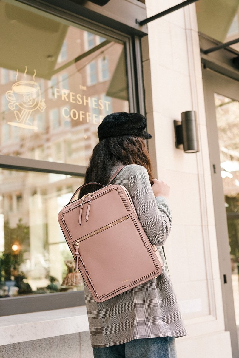 women with mauve pink CALPAK Kaya laptop backpack