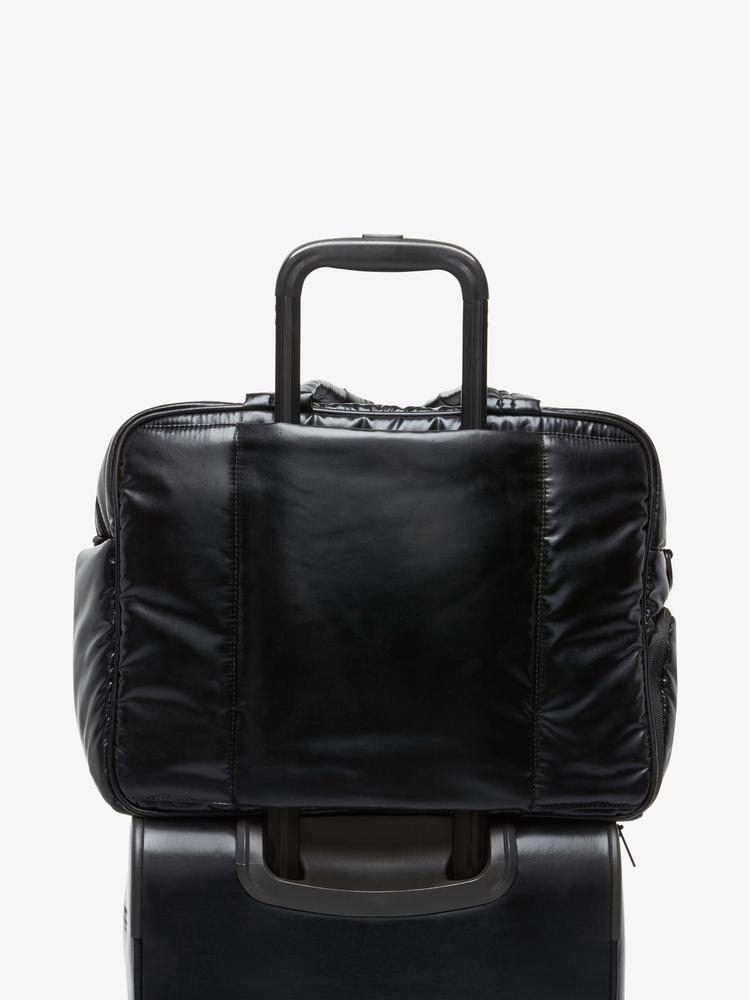 black CALPAK Luka duffel bag with luggage trolley sleeve