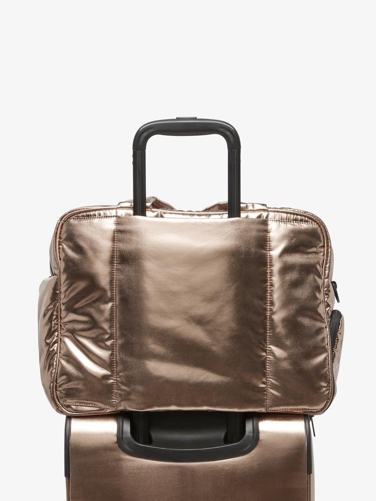 gold bronze CALPAK Luka duffel bag with luggage trolley sleeve