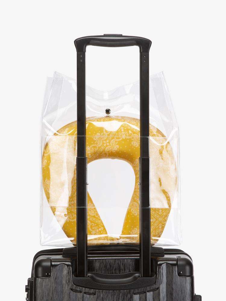 CALPAK mustard travel neck pillow with eye mask in clear carry bag