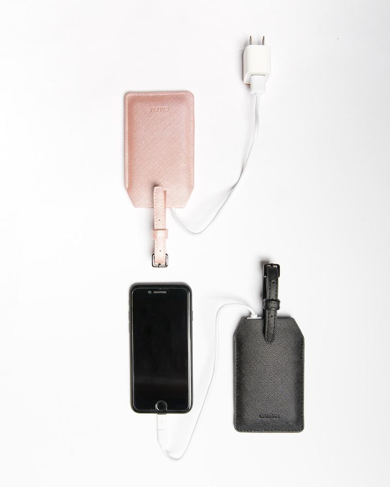 pink and black vegan leather luggage tags with portable chargers inside