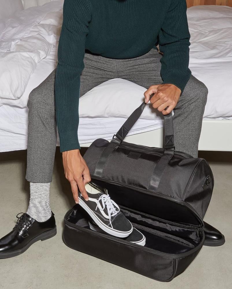 shoe compartment in black CALPAK Stevyn duffel bag